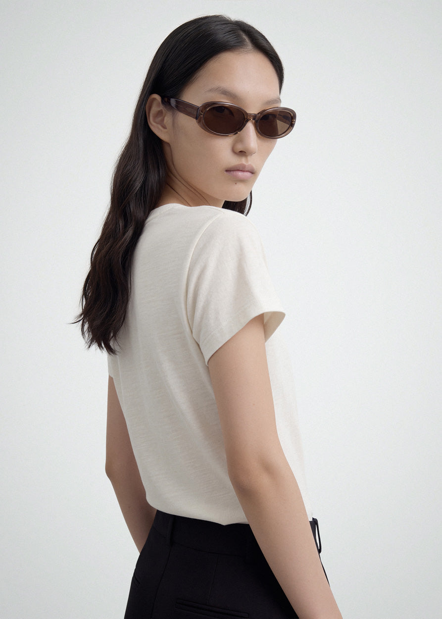 A model wearing Valentina Transparent Brown sunglasses by DMY Studios.